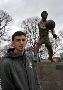 David Stockton next to a statue of his father which stands outside the Utah Jazz home stadium